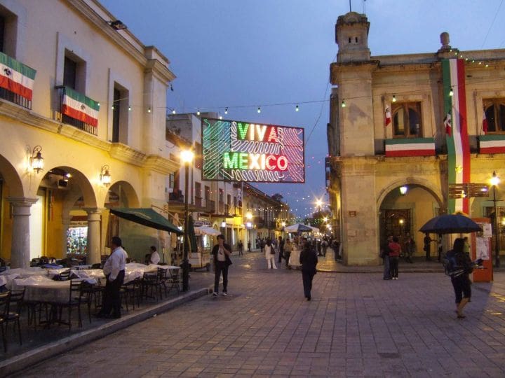 Small town square in Mexico decorated with Mexican flags